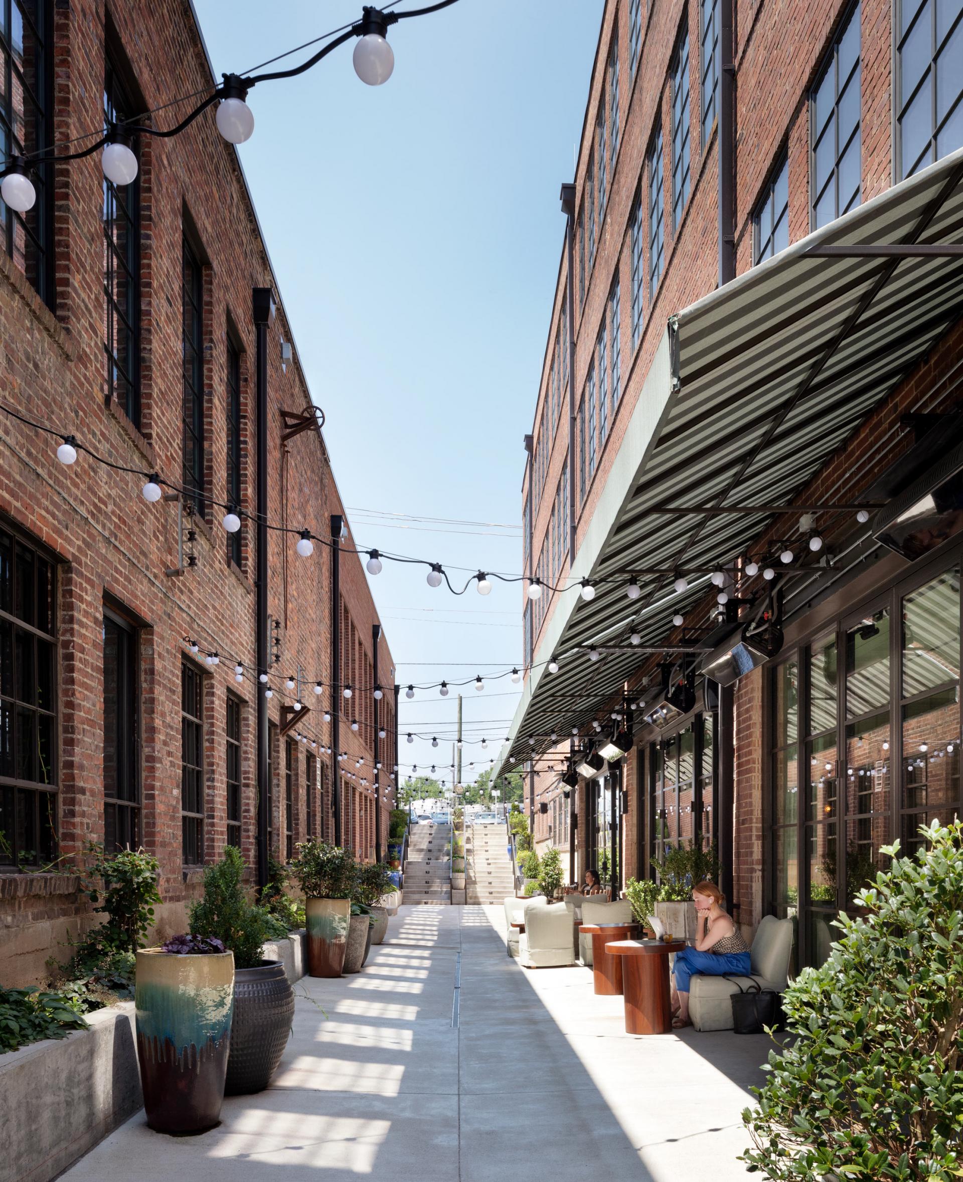 The adaptive reuse, renovation, and restoration of the historic buildings spanned more than five years. Steel grids from existing windows and original bricks were preserved, creating patterns new and old.