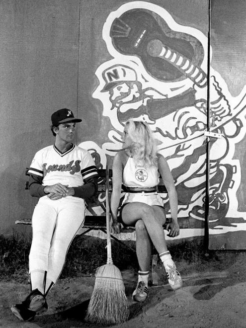 Nashville Sounds Kenny Baker, left, passes the time chatting with Soundette Shawn Williams, who hurried off moments later to sweep the bases in their game against Chattanooga at Greer Stadium Aug. 17, 1980.